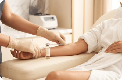 Clinician drawing a small blood sample from a patient’s arm for PRF